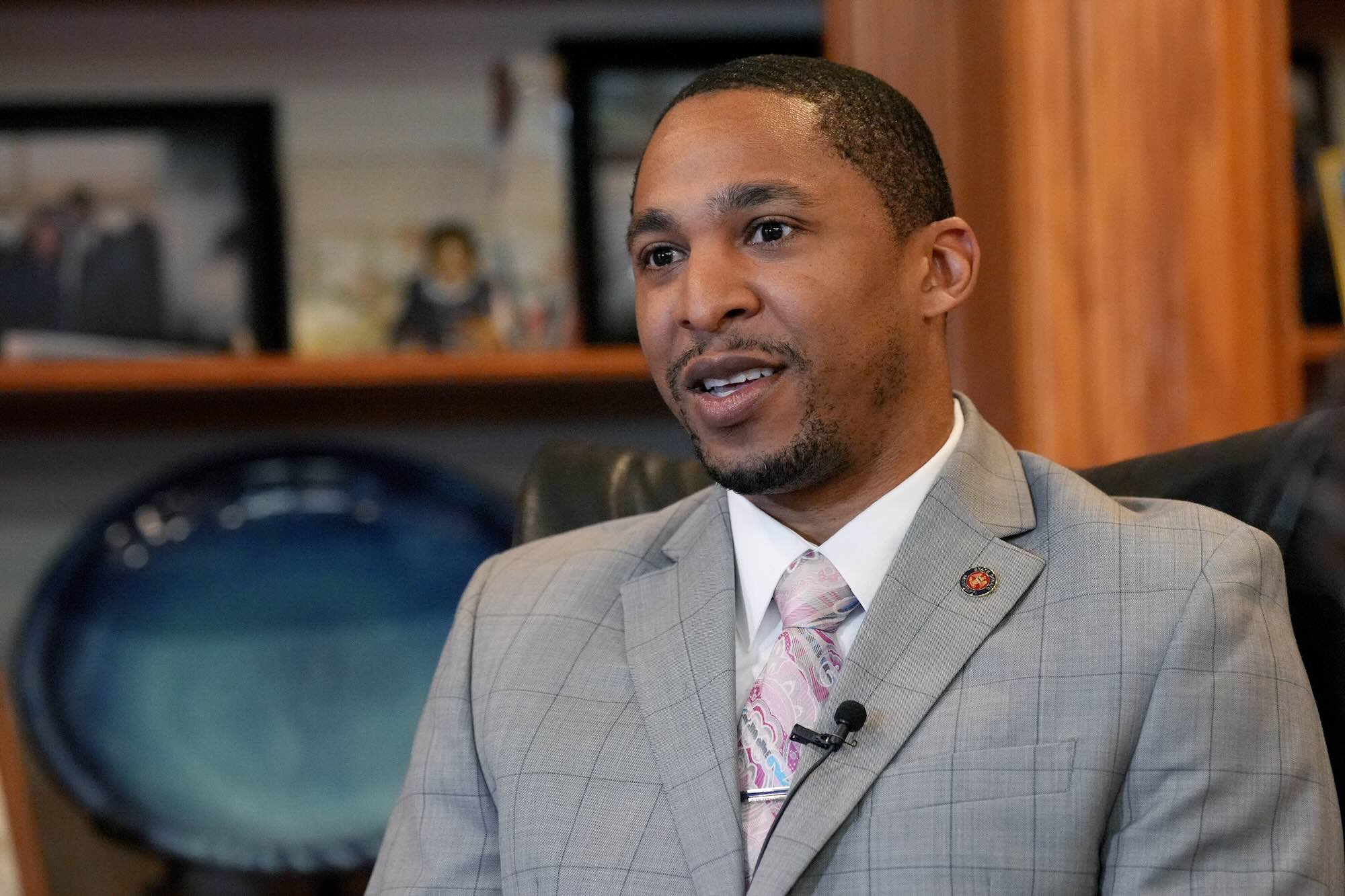 A closeup of Bradford Blackmon, seated in an office, speaking