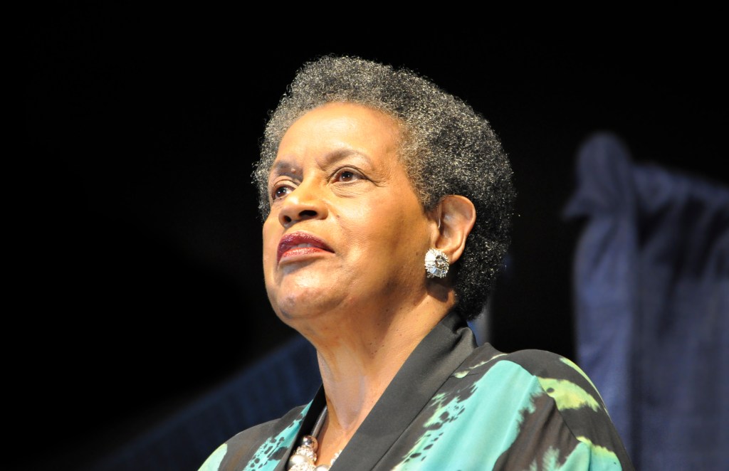 A closeup of Myrlie Evers on a stage, speaking