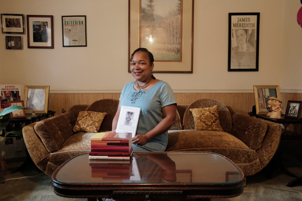 a photo of a woman sitting on a couch at a coffee table