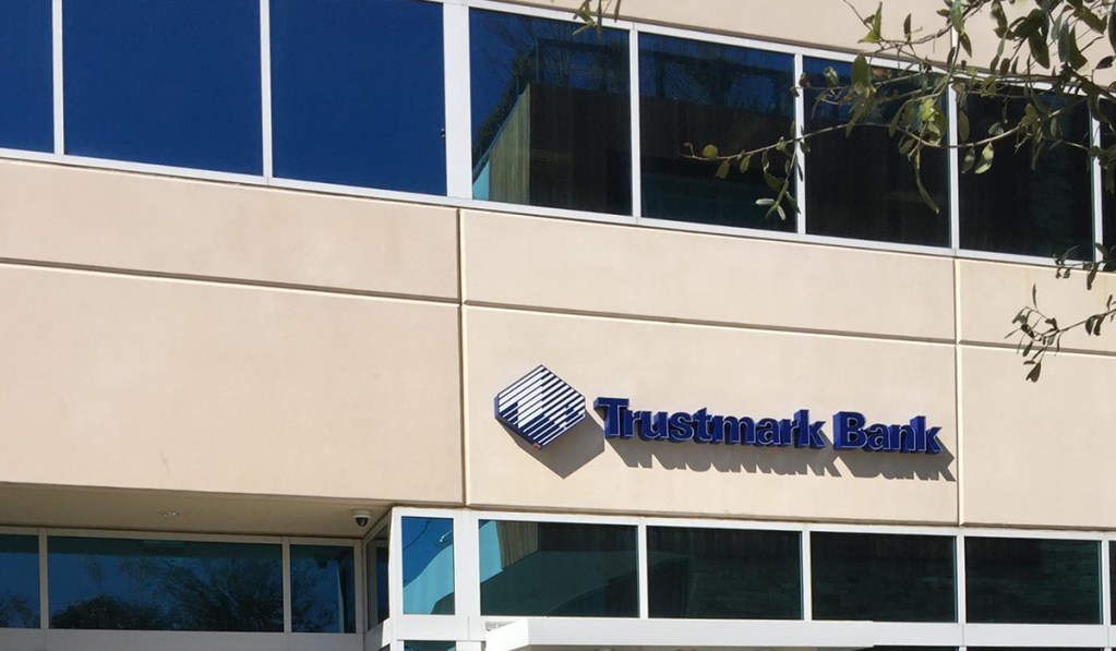 An exterior of a building labeled 'Trustmark Bank'