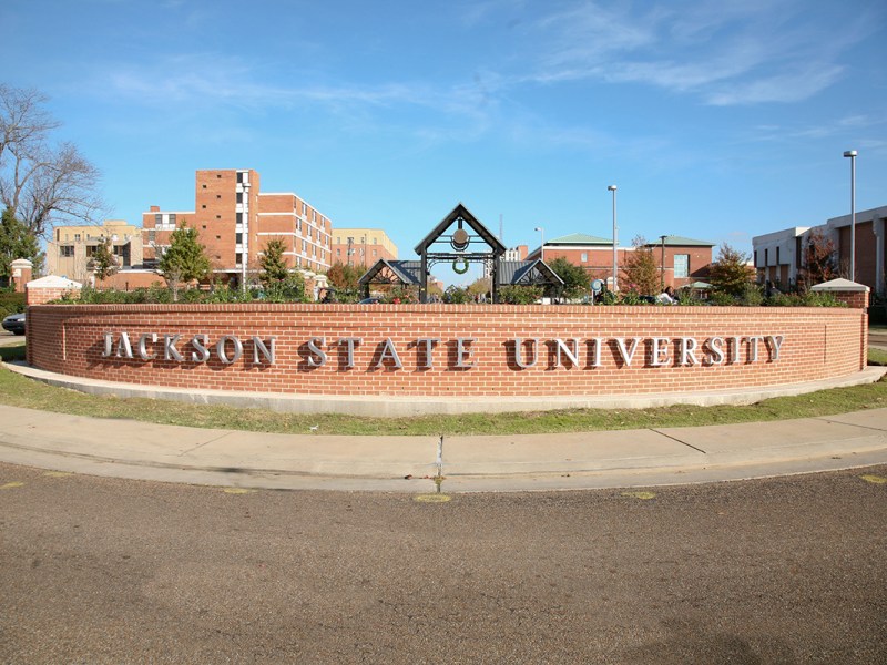 A brick wall with letters that spell out “Jackson State University.”