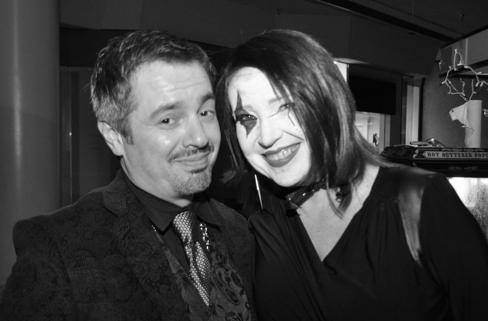 A black and white photo of Todd Stauffer and Donna Ladd. Donna has her face painted harlequin style.