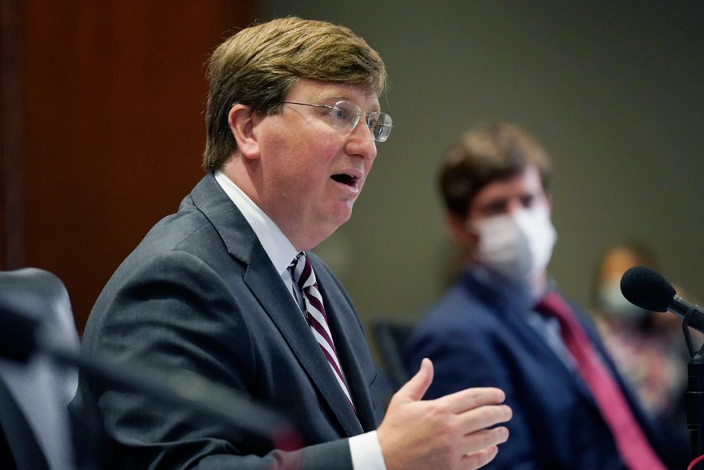 Governor Tate Reeves speaks while Dr. Thomas Dobbs listens
