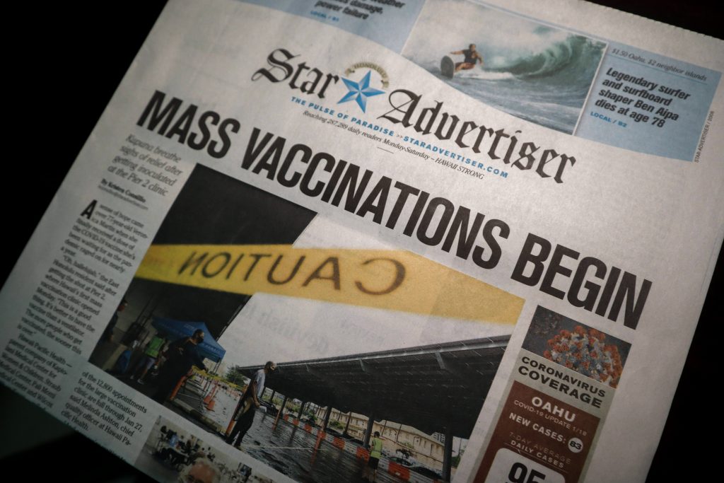 Stock photo of newspaper the Star Advertiser headline mass vaccinations begin