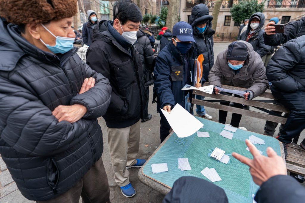 A detective in New York's Chinatown neighborhood handing out leaflets