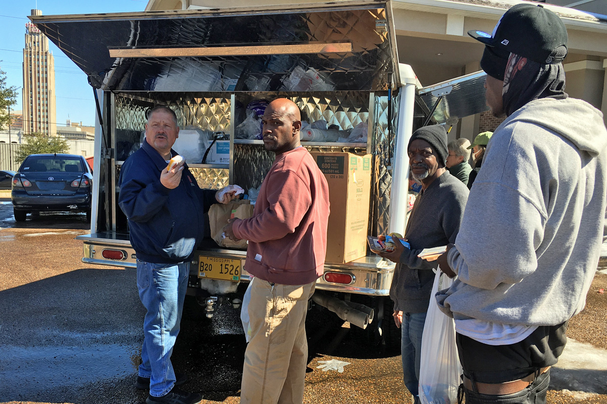Major Robert Lyle passing out food to the homeless