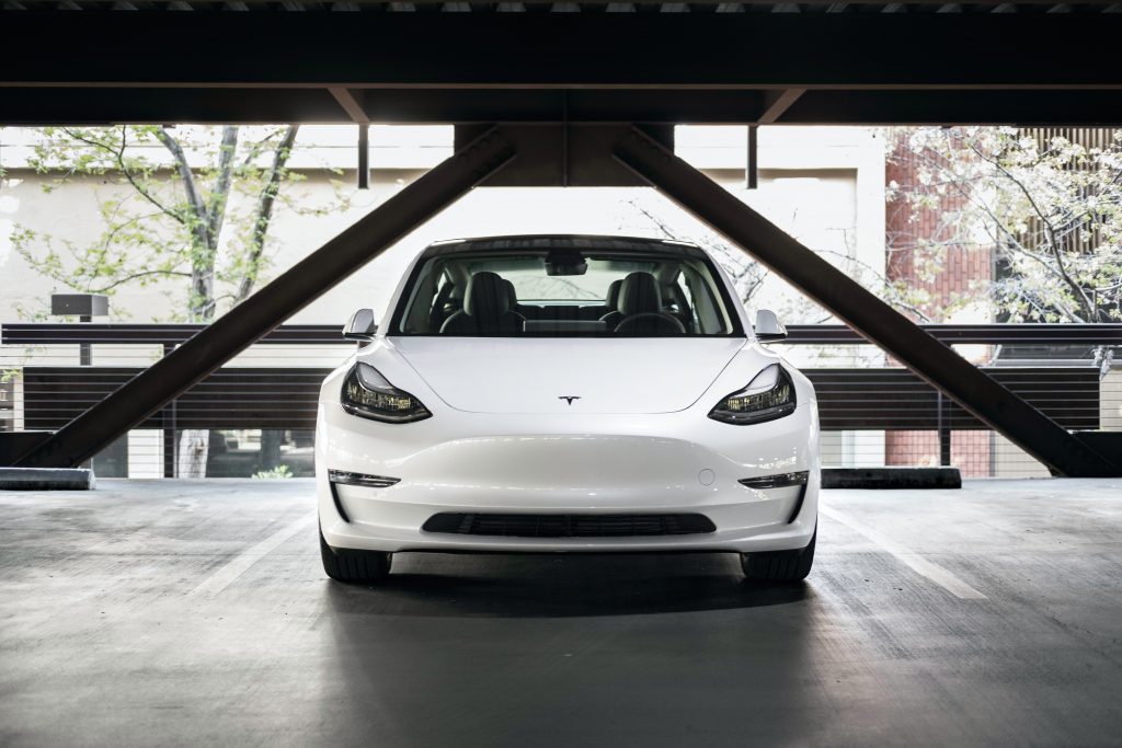 front of white Tesla
