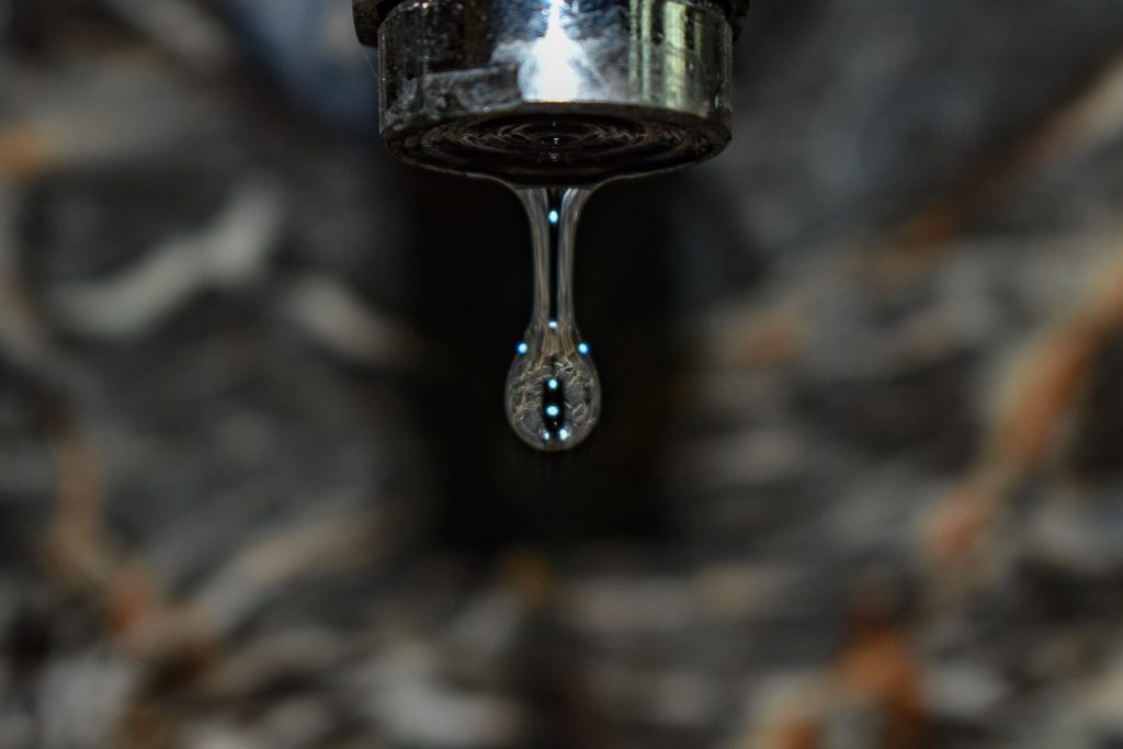 drop of water hanging from faucet