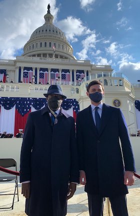 Raphael Warnock and Jon Ossoff stand in front of the US Capitol at Biden's inauguration