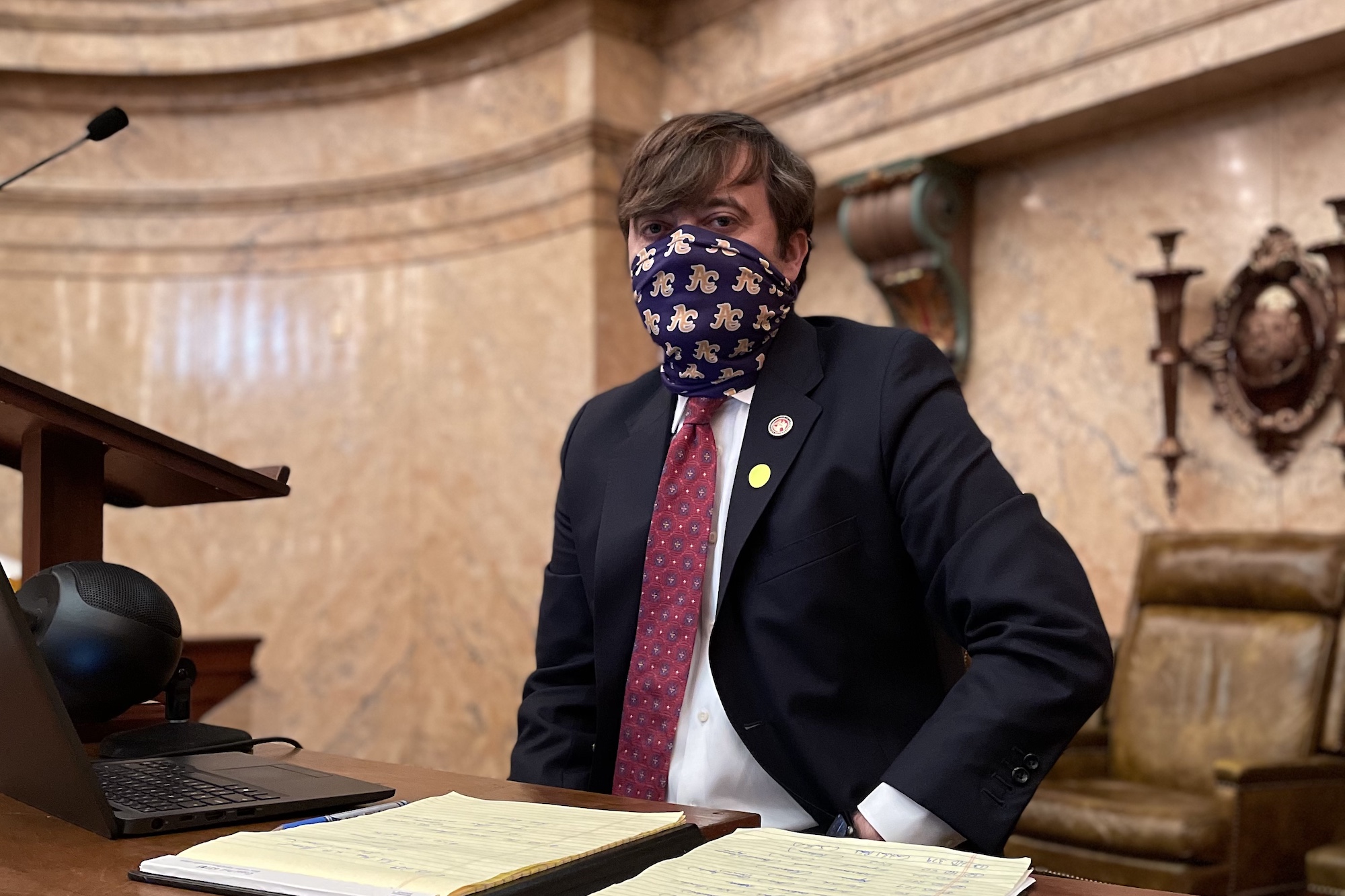 Representative Nick Bain, wearing a mask, stands in the Mississippi House