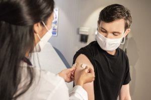 Person getting a vaccine inside of a clinic