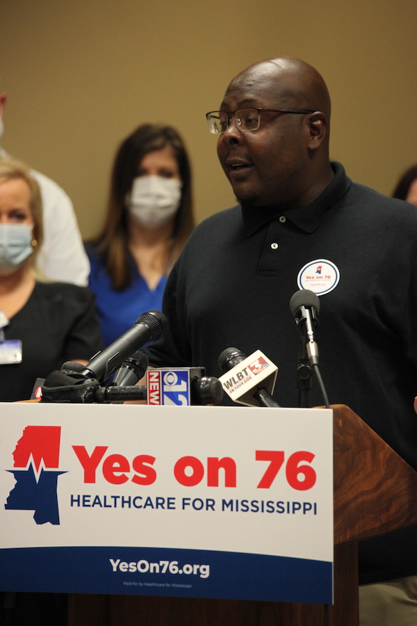 Jonathan Smith stands at the podium to support Yes on 76