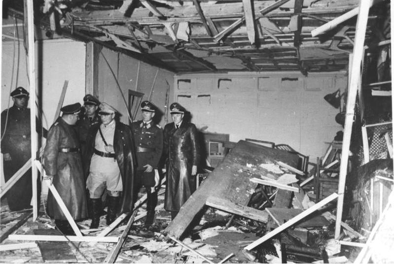 S.S. officers survey a conference room where a 1944 blast failed to kill Adolf Hitler