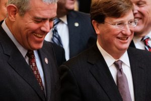 Philip Gunn and Tate Reeves stand amid a group of lawmakers