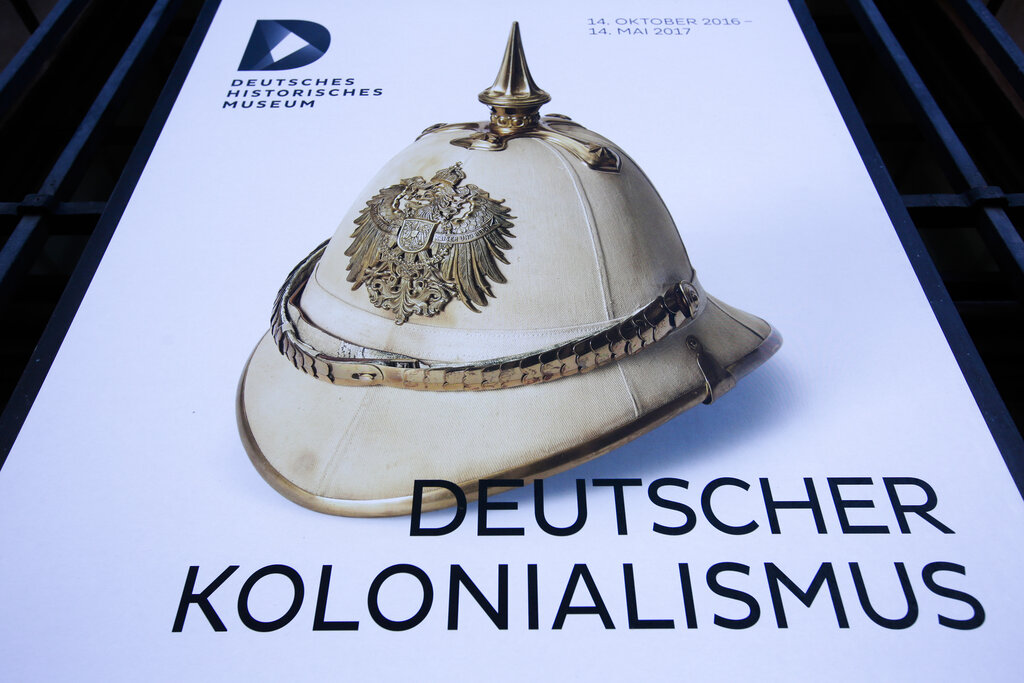 A poster for the exhibition 'German Colonialism' with a historic German spiked helmet displayed outside the German Historic Museum in Berlin, Friday, Jan. 6, 2017.
