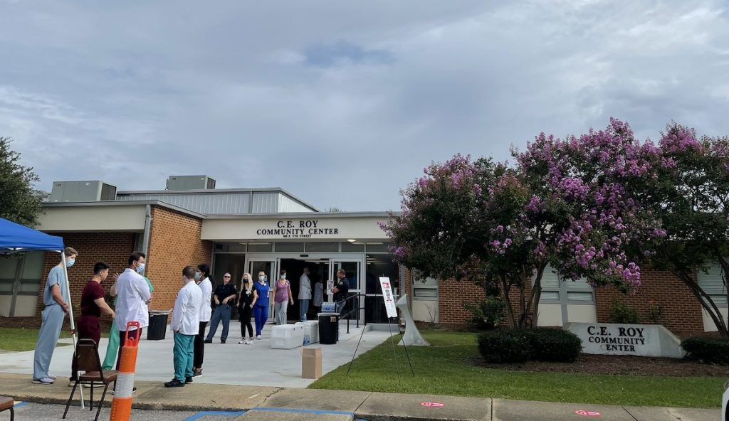 Doctors and people arrive at the C.E. Roy Center for a vaccine clinic