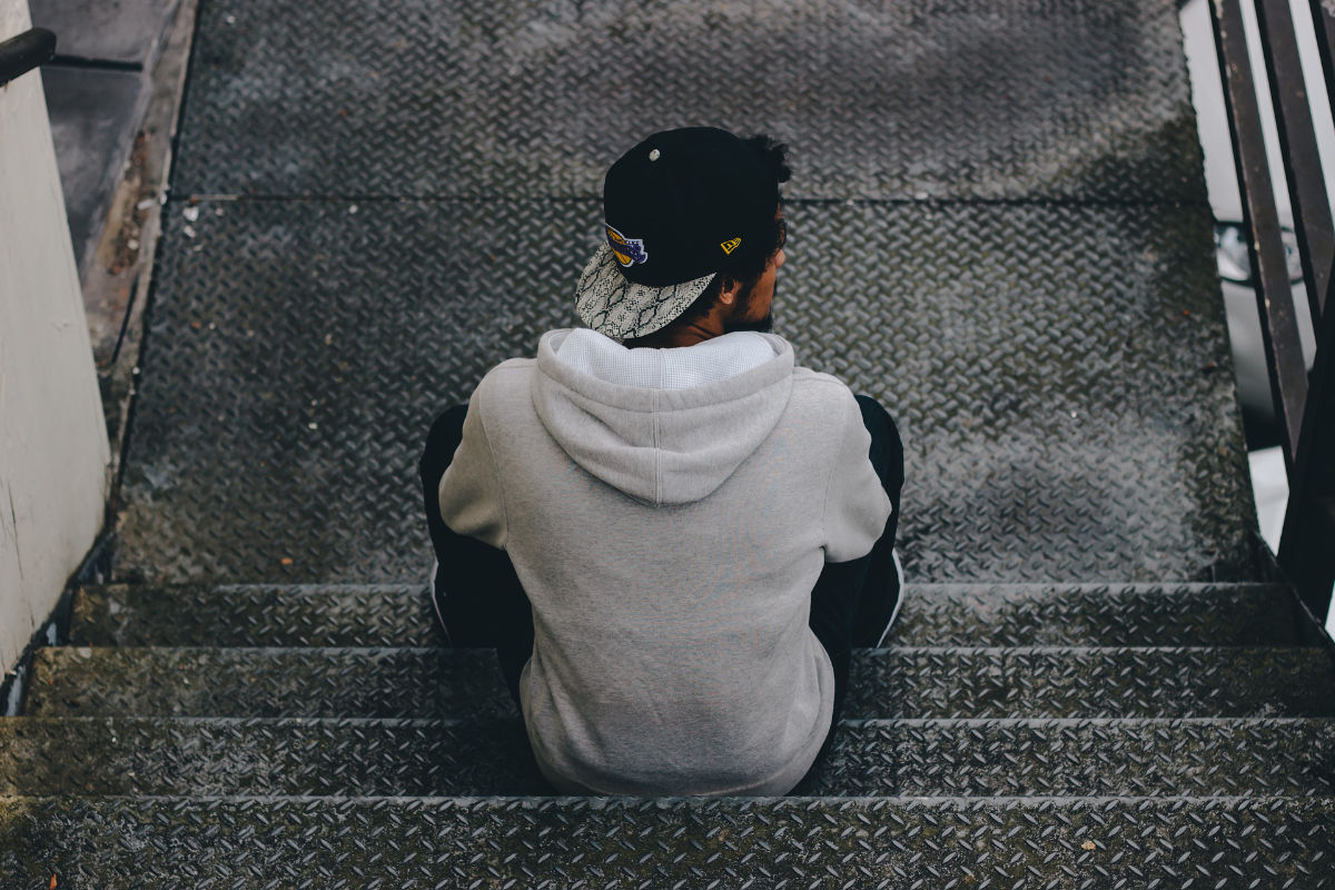 Man sitting on stairs, facing away