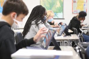 K-12 students use tablets to work at their desks