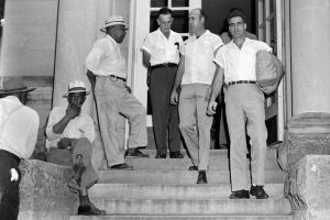 Black and white photo of men outside of the Leflore County Courthouse
