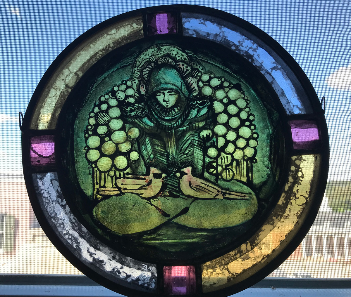Wendy Eddleman's stained glass pice Nurtured, with a sitting figure in the center