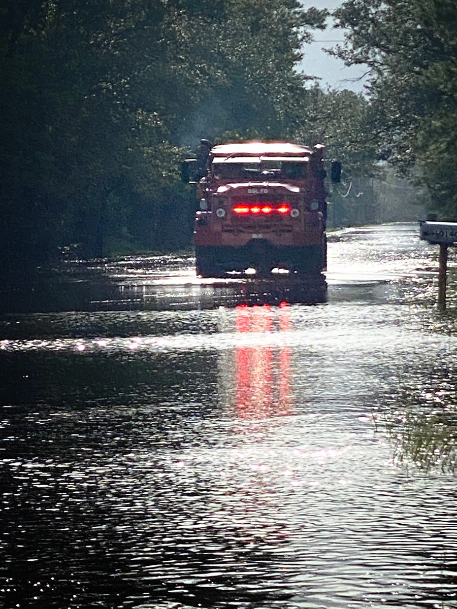High-water rescue trucks ride through flooded neighborhoods in search of anyone in need of assistance
