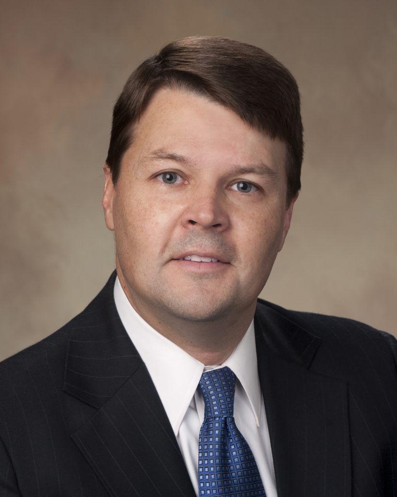 Headshot of University of Mississippi MacAuthur Justice Center Director Cliff Johnson in black suit and blue tie