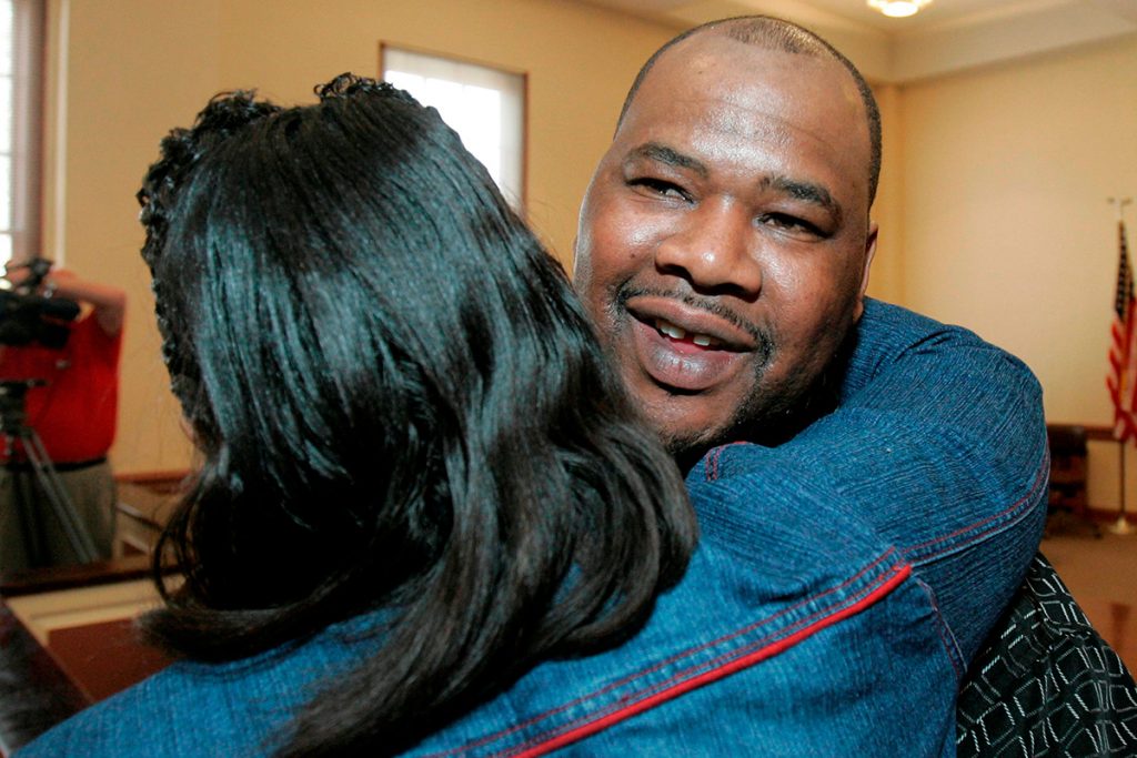 FILE-In this Friday, Feb. 15, 2008 file photo shows Kennedy Brewer, right, hugged by a friend, moments after a circuit court judge exonerated him for the kidnapping and murder of a 3-year-old girl in Macon, Miss. Convicted in 1995 of raping and killing his girlfriend's 3-year-old daughter and sentenced to death. In 2001, DNA testing proved that Brewer was innocent. Since 2000, at least 18 men convicted in rapes and murders largely because of bite-mark analysis have been exonerated by DNA testing or otherwise proved not guilty. (AP Photo/Rogelio V. Solis, File)