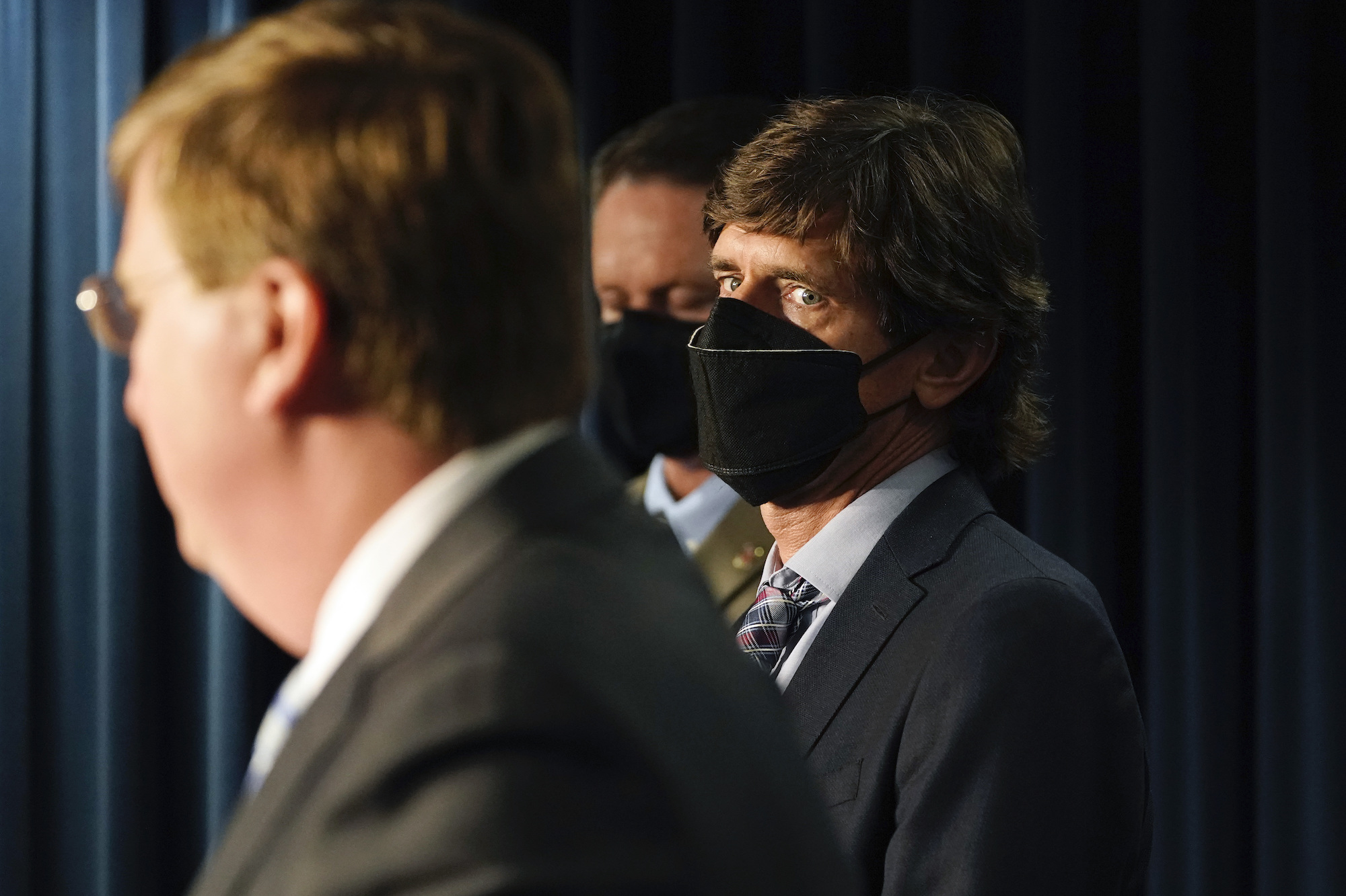 A photo of Dr. Thomas Dobbs looking at Gov. Tate Reeves