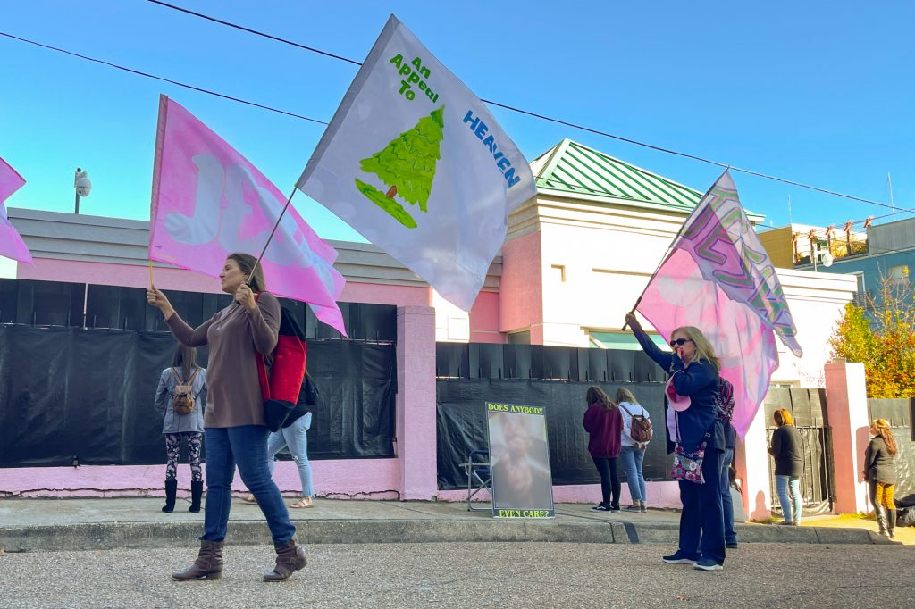 a protestor carries an appeal to heaven flag outside the state's only abortion clinic