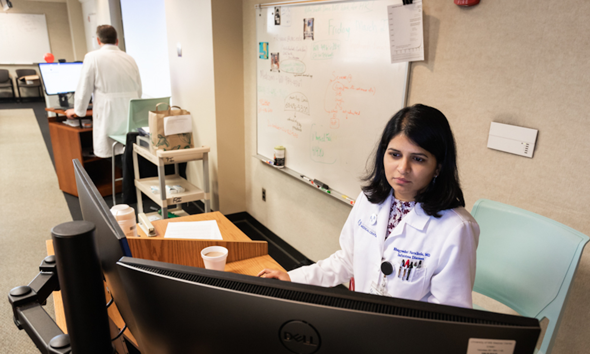 a photo of Dr. Bhagyashri Navalkele at a computer at UMMC