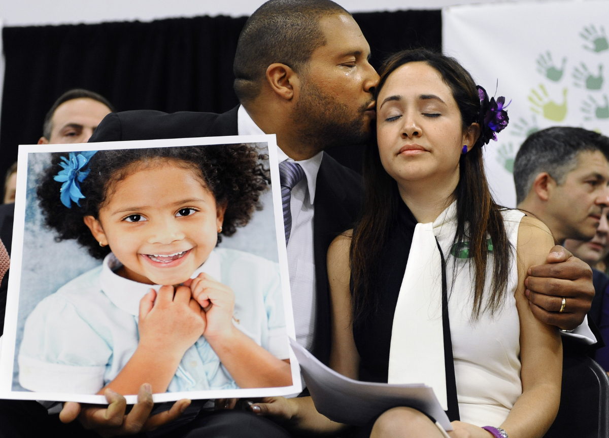 Parents of Ana Marquez-Greene, killed at Sandy Hook, hold a photo of their child.