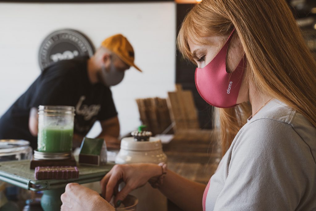 Masked people in what looks like a coffee shop