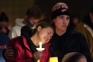 People attend a vigil for the victims of a school shooting that occurred in Oxford, Michigan, on Nov. 30, 2021