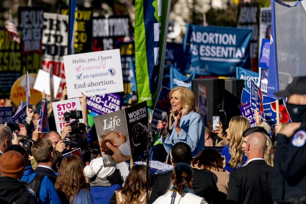 a photo of Lynn Fitch surrounded by anti-abortion activists