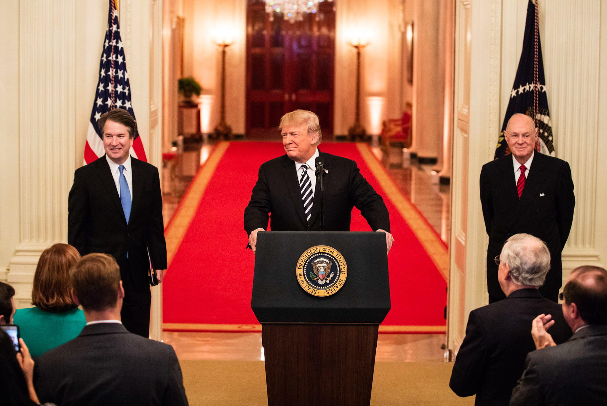 Donald Trump at a podium next to Anthony Kennedy and Brett Kavanaugh