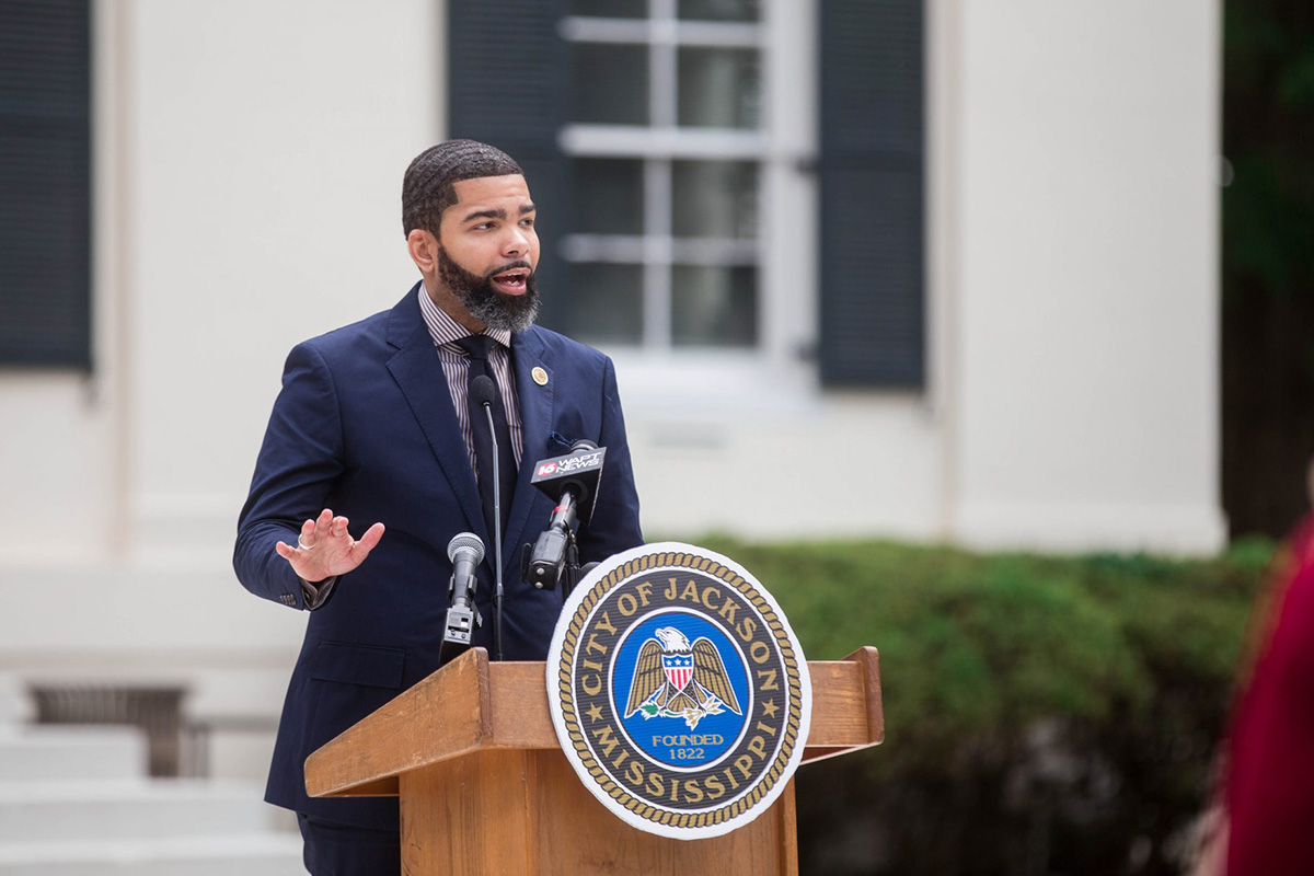 Mayor Chokwe A. Lumumba speaking at a podium outside of City Hall