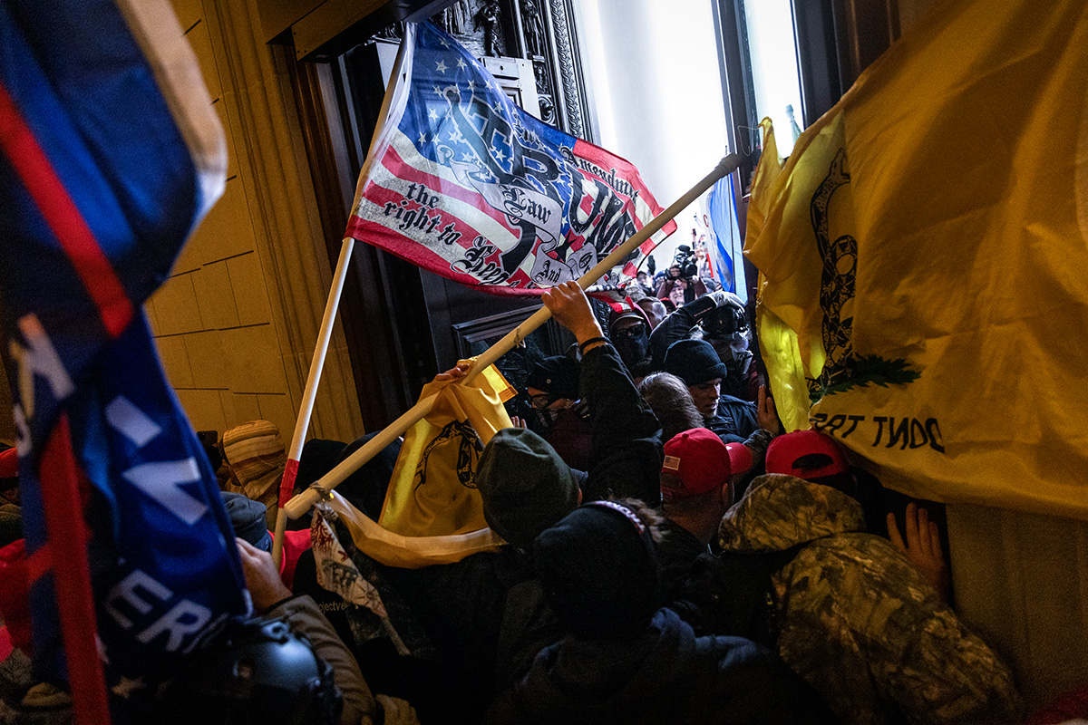 "Rioters bearing flags breaking into the Capitol building