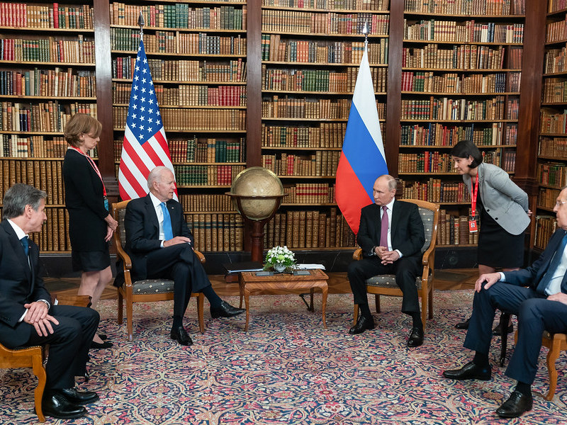 a photo of Biden and Putin sitting across from one another
