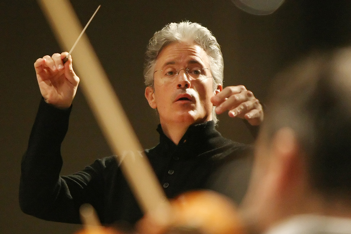 Close up of a man conducting an orchestra