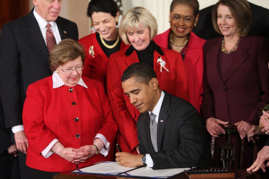 President Barack Obama signs into law the Lilly Ledbetter Fair Pay Act in the East Room of the White House.