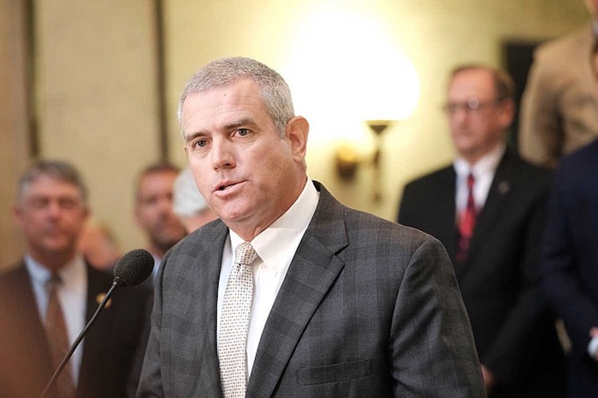 Philip Gun speaking at podium
