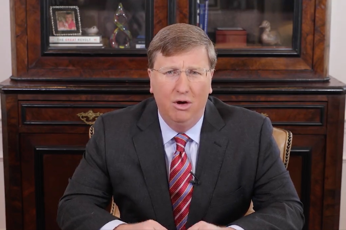 A photo of Governor Tate Reeves at his desk