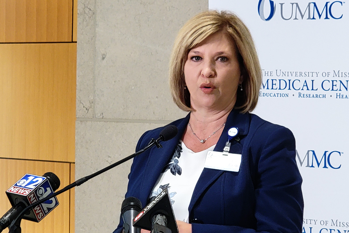 Dr. LouAnn Woodward speaking at a podium