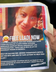 A print out of a flier that says FREE LLADI NOW over the photo of a woman