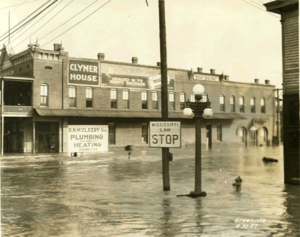An old black and white photo of a flooded downtown street