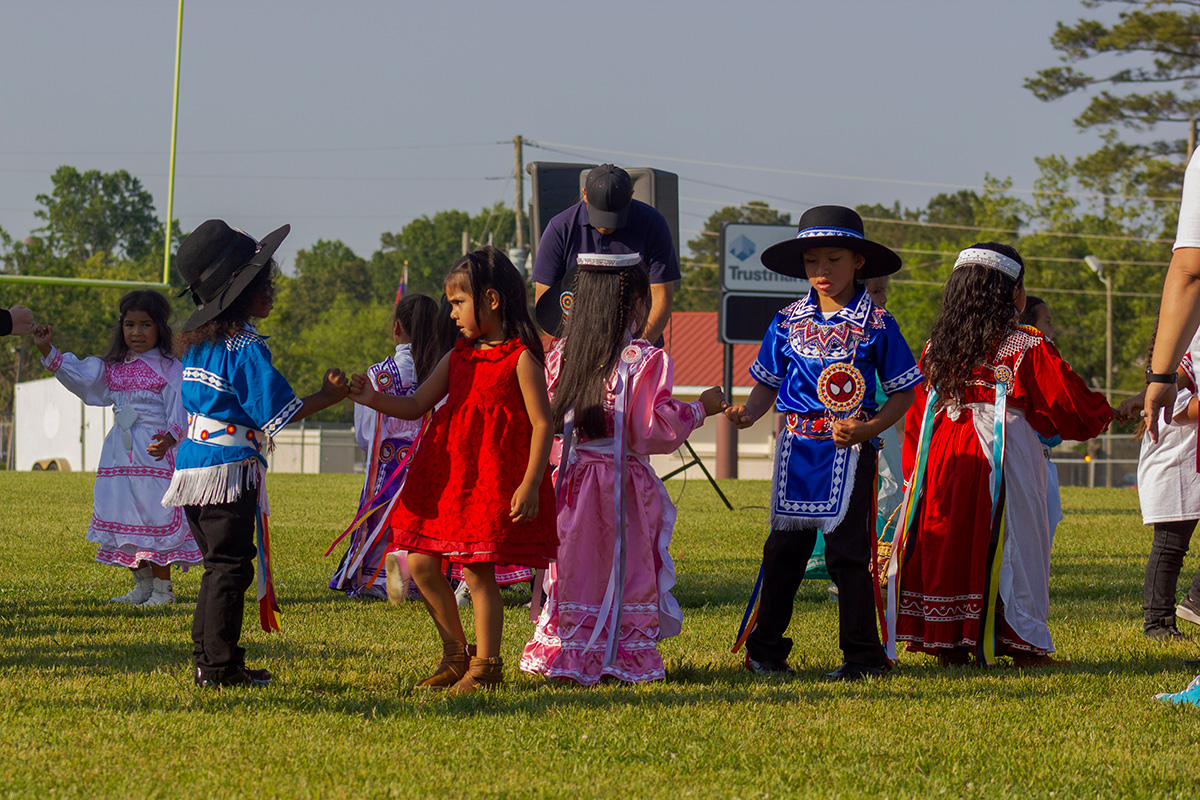 young boys and girls in colorful dress, dancing
