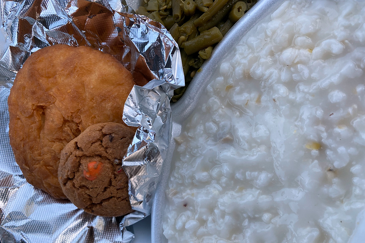 A plate of hominy, fry bread and green beans