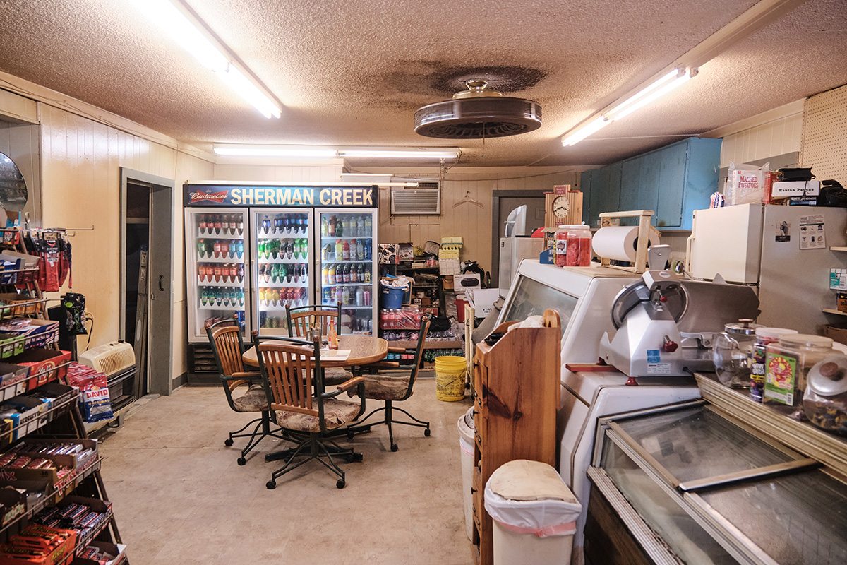 Interior view of Sherman Creek Grocery as the sign says over the drink cooler
