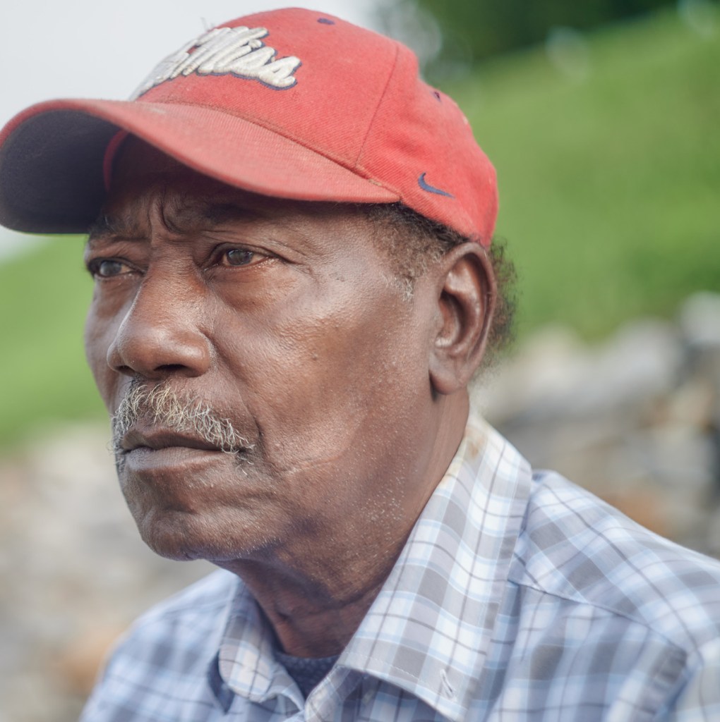 A headshot of a man in a red Ole Miss hat