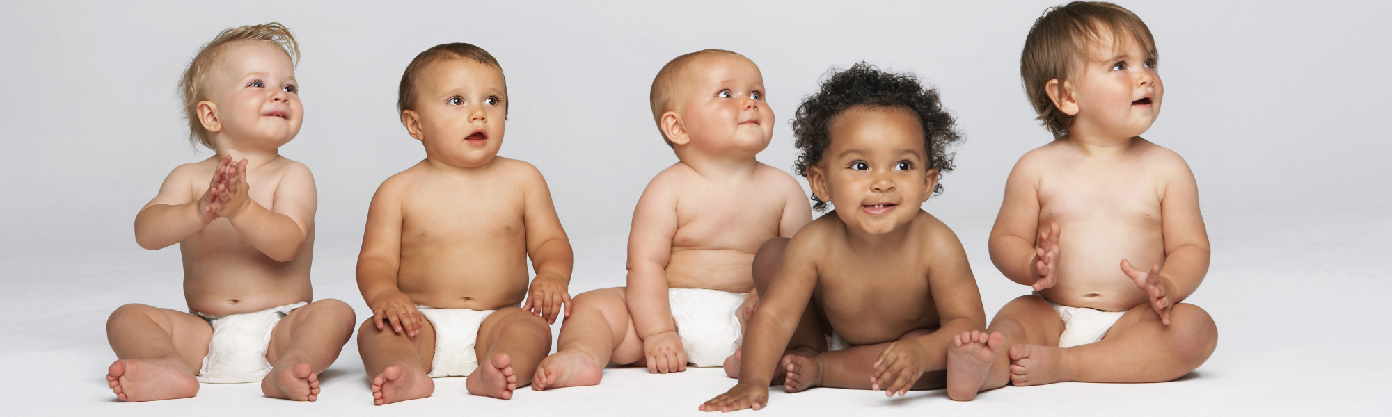 Photo of five babies in white diapers